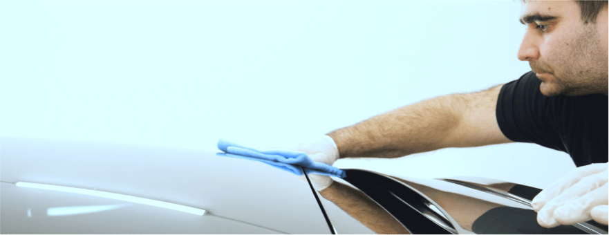 man drying a freshly washed car